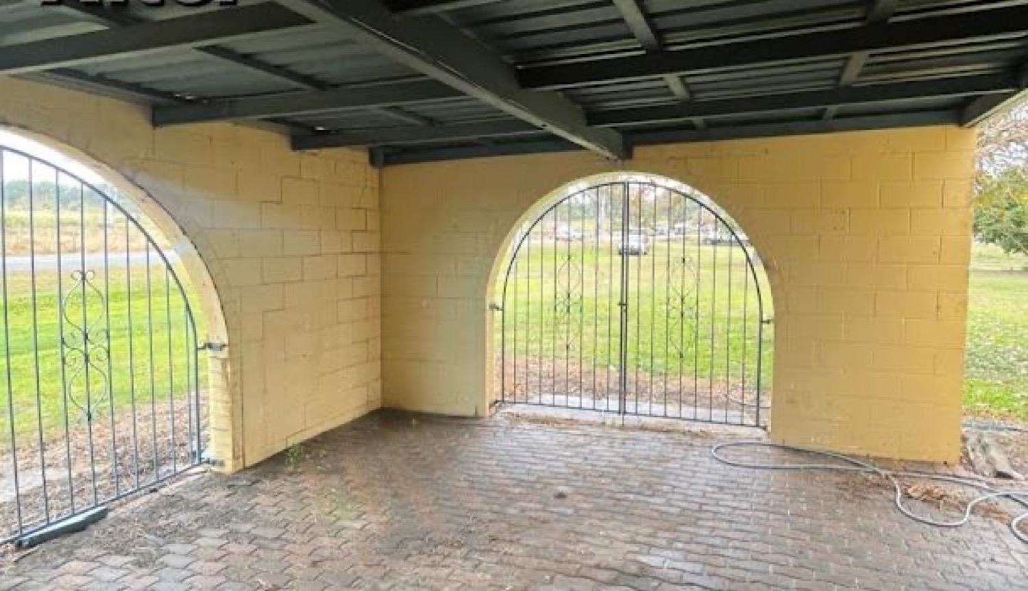 A clean brick paver carport archway